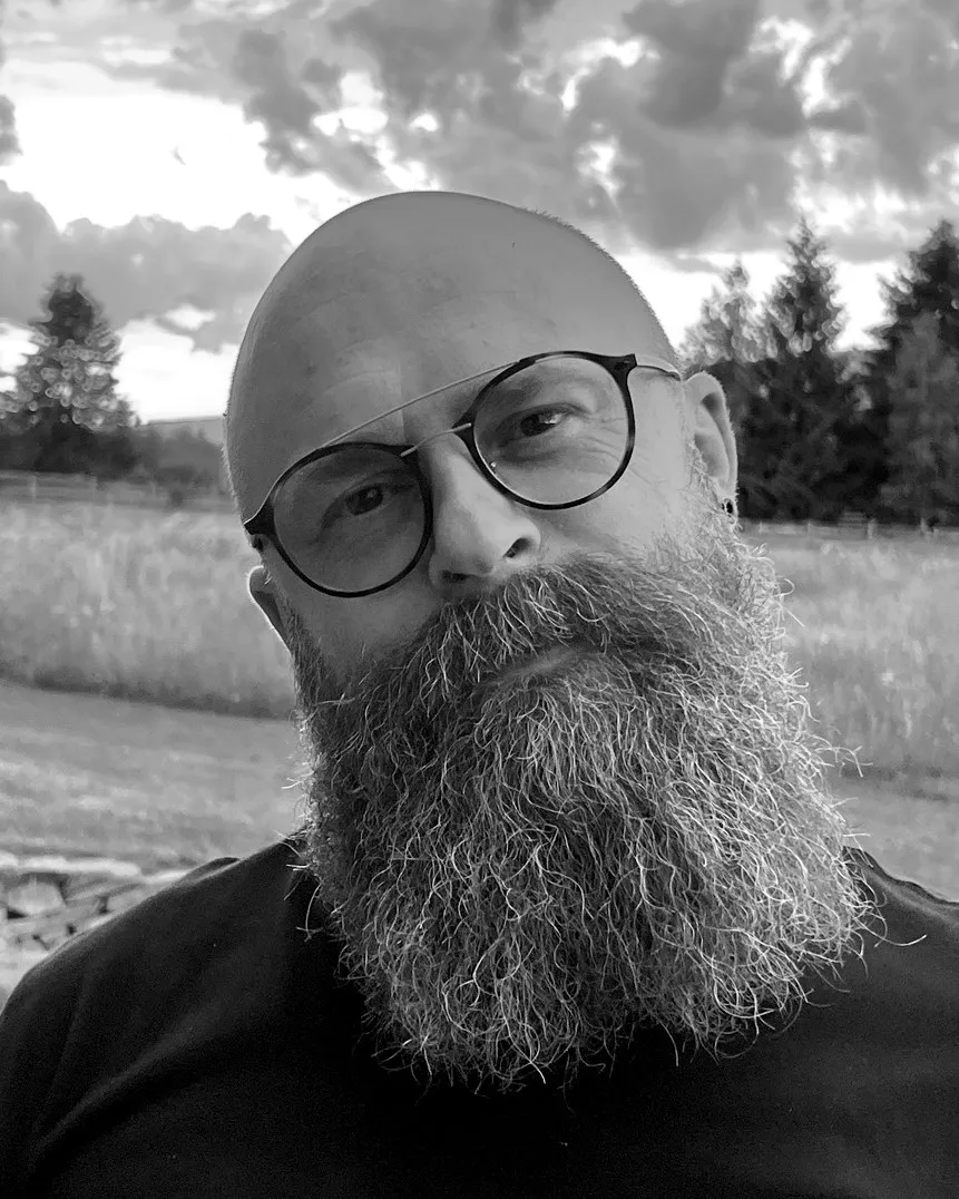 Black and white portrait of Botond Ferenczy, bald with a long beard and round glasses