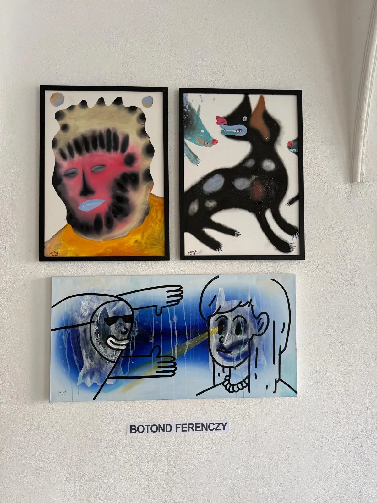 Boti’s wall: a masked face, a black dog and two blue figures above his name