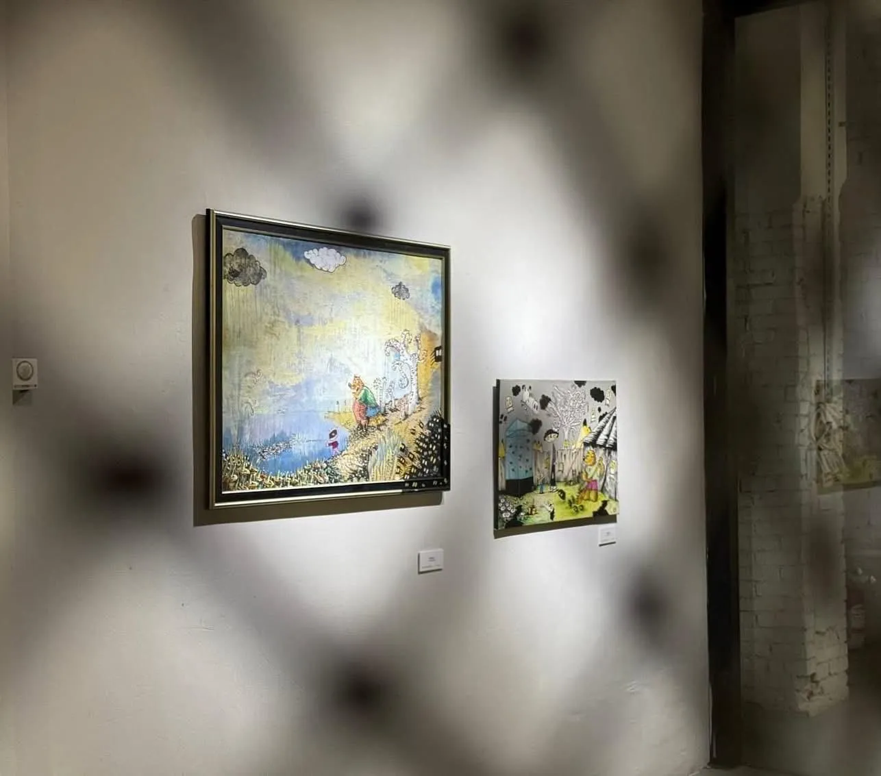 Two of Boti’s story landscapes on the gallery wall